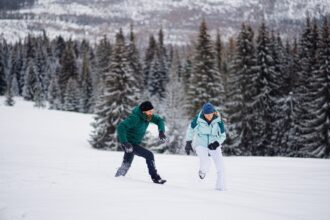 Mature couple having fun outdoors in winter nature, Tatra mountains Slovakia.