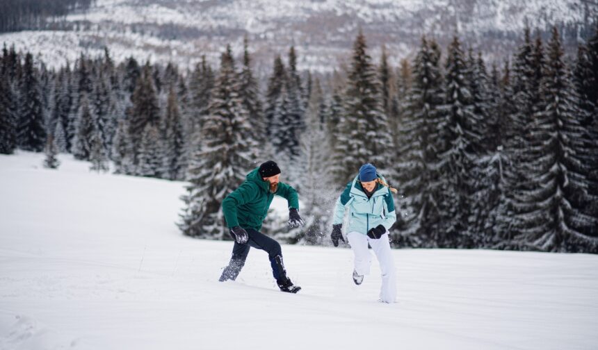 Mature couple having fun outdoors in winter nature, Tatra mountains Slovakia.